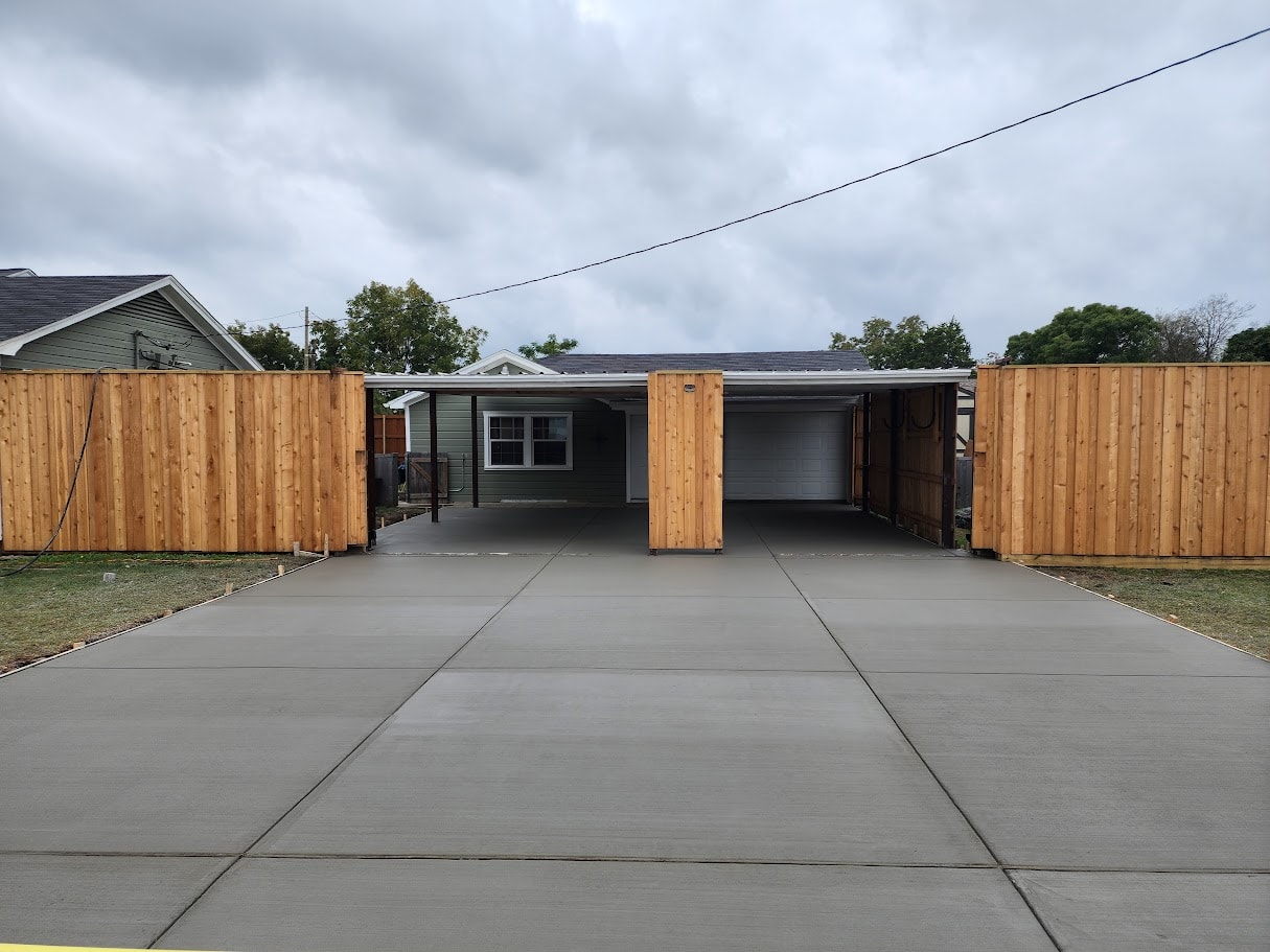 After: finished concrete driveway at brick home in DFW